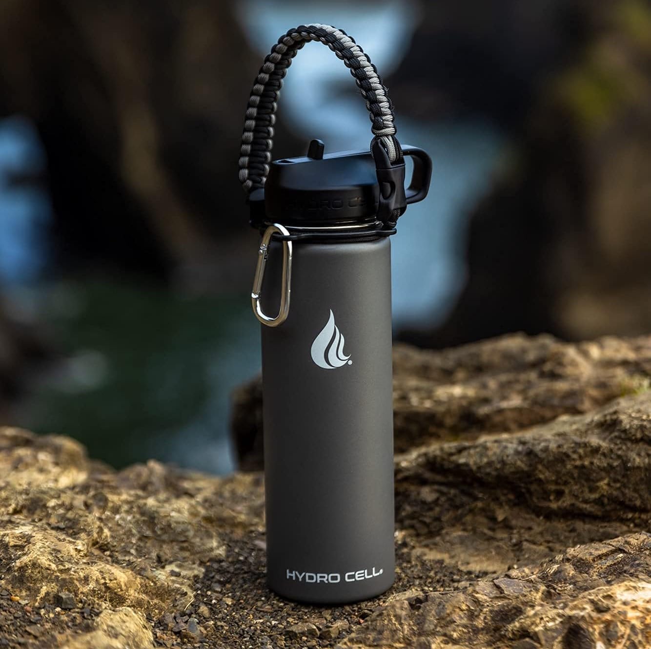 HYDRO CELL Paracord Handle for Wide Mouth Water Bottles - Carrier Strap w/Attachment Ring and Carabiner Accessory. Compatible w/ 64oz, 40oz 32oz, 24oz, 18oz, 14oz Insulated Bottles (Graphite/Black)
